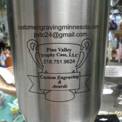 Stainless steel tumbler featuring engraved contact info for Pine Valley Trophy Case, LLC, offering custom engraving and awards.