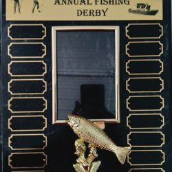 A black and gold plaque for the Homer Family Annual Fishing Derby, featuring empty nameplates and a fish trophy.