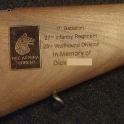 Inscription on a rifle stock honoring a member of the 27th Infantry Regiment, 25th Wolfhound Division.