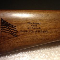 Engraved rifle stock with an American flag and the message: "With Respect, Honor, and Gratitude THANK YOU VETERANS!.