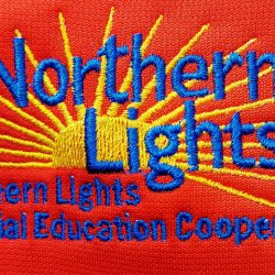 Embroidered logo reading "Northern Lights Special Education Cooperative" over a yellow sunburst on a red background.